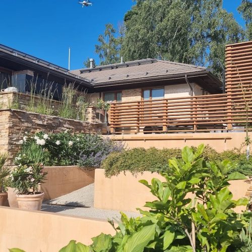 Talo, jossa on kansi ja suuri puutarha. Mukana myös ulkona, rakennuksena, taivaana.