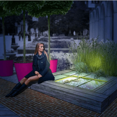 Henkilö, joka istuu penkillä. Kuvassa on mustia värejä. Sisältää myös vaatteita, jalkineita, kasveja.